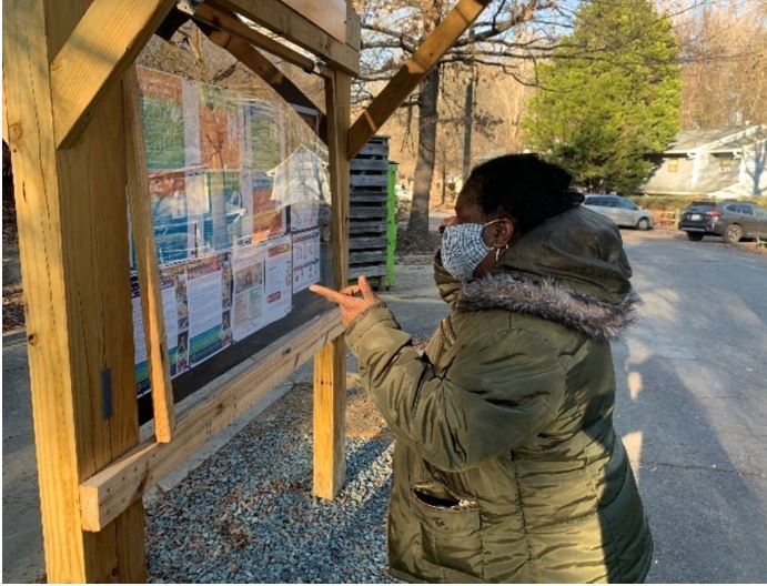 Resident viewing outdoor info kiosk